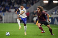 | Photo: AP/Laurent Cipriani : 2024–25 UEFA Nations League, France vs Belgium: Kylian Mbappe, left, and Belgium's Wout Faes fight for the ball